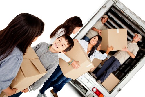 Moving team loading furniture safely with protective equipment